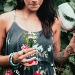 womens-fashion-tattooed-woman-holding-flowers-and-wine-150x150